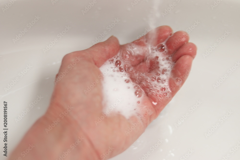 Fototapeta premium Woman washing hands with soap and in bathroom. Hygiene and virus and disinfection. Cleaning hand with soap and water.