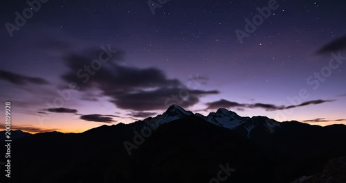 Majestic mountain range at sunset with vibrant clouds and twilight sky, serene and tranquil