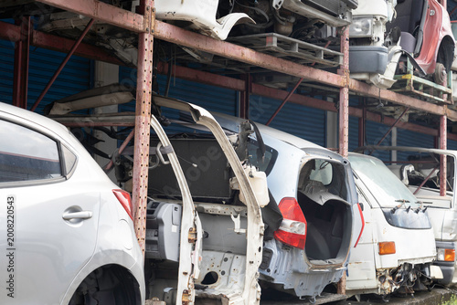 Auto parts warehouse. Wrecked car, Scrap car, Junk car on shelf at garage. Automotive spare parts warehouse