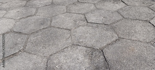 Valokuva Top view of hexagonal concrete paving stones forming a geometric pattern, gray rough surface with joints