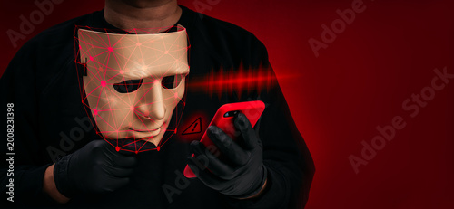 Deepfake identity concept with masked face and facial recognition overlay using smartphone. AI fraud, digital impersonation, voice scam, identity theft, cybercrime risk and biometric security threat.