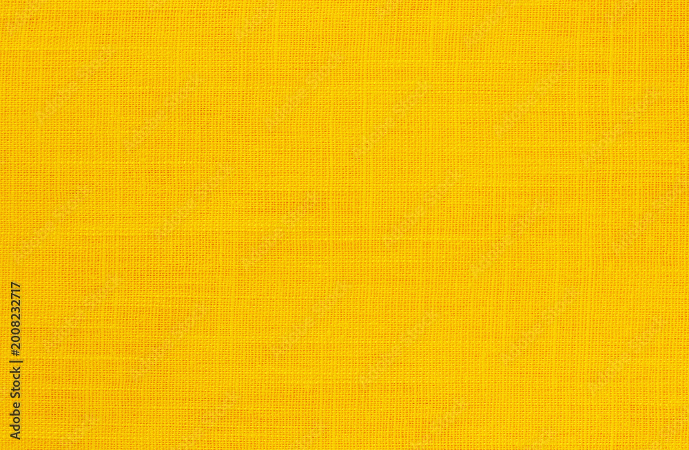Fototapeta premium Yellow linen fabric cloth texture background, seamless pattern of natural textile.