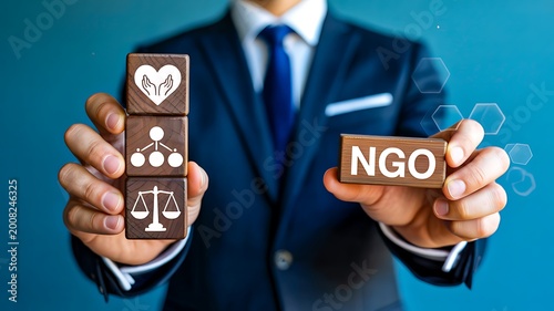 NGO concept with businessman holding blocks representing support ethics and social responsibility