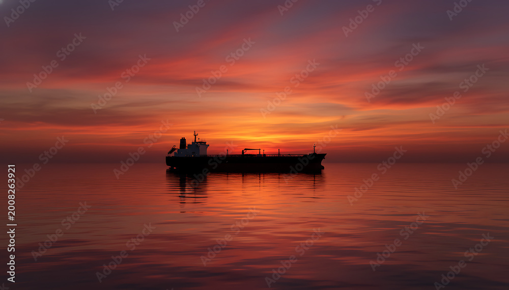 Obraz premium A solitary modern crude oil tanker silhouetted against a vibrant fiery orange and purple sunset on calm waters