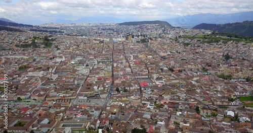 Aerial flight over Quito historic old town with modern skyline in background Ecuador