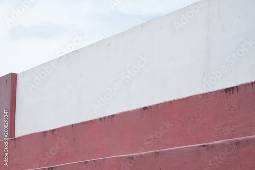 Abstract pink grunge wall texture with peeling paint, cracked plaster, and distressed vintage surface. Weathered dusty rose background featuring rough aged details, faded color variations, and natural