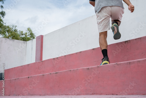 Obraz na plátně running up outdoor steps, Rear view of elderly man in sportswear running quickly