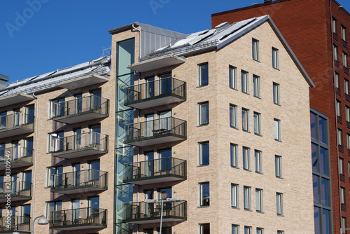 Εκτύπωση καμβά Modern residential apartment building with multiple balconies and large windows,
