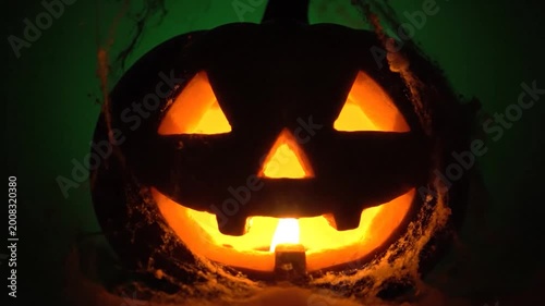 A glowing, carved gourd with a candle inside, creating a spooky and festive atmosphere for a seasonal celebration