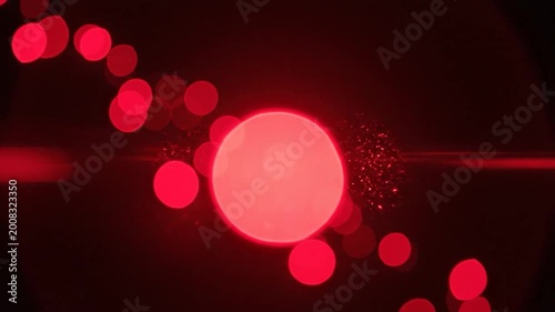 Abstract background with red bokeh lights on a dark background. Beautiful and artistic blurred lights for a modern design