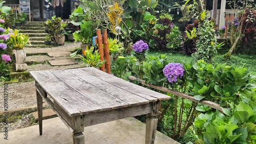 Authentic Javanese Heritage Site: A Rustic Table Amidst a Flowering Garden