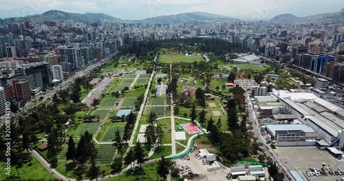 Aerial establishing shot of La Carolina Park and Quito skyline, Ecuador