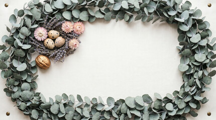 Speckled quail eggs with dried flowers inside a beautiful eucalyptus leaf wreath
