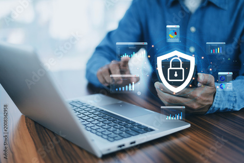 Businessman using laptop with cybersecurity protection and data privacy interface, digital security concept, business security, cyber attack prevention, data safety, privacy protection