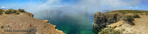 beautiful view on a bay covering by a blur cloud in the sky between the cliff...