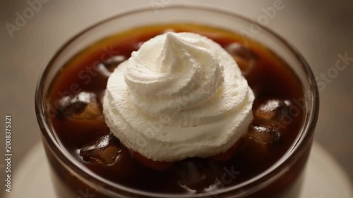 Whipped cream topping on coffee creating soft creamy texture extreme close up dessert beverage shot