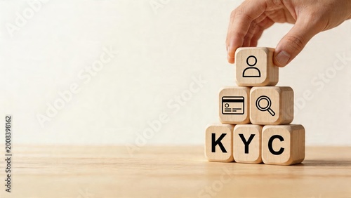 Business man stacking wooden blocks building tower with KYC Know Your Customer concept identity verification icons security check process compliance regulation framework finance