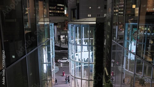 Night in Tokyo : Futuristic Glass-Enclosed Space within a Multi-Layered Urban Environment with Illuminated Vertically Moving Cylindrical Glass Buildings  |  Shibuya Station Area, Tokyo, Japan