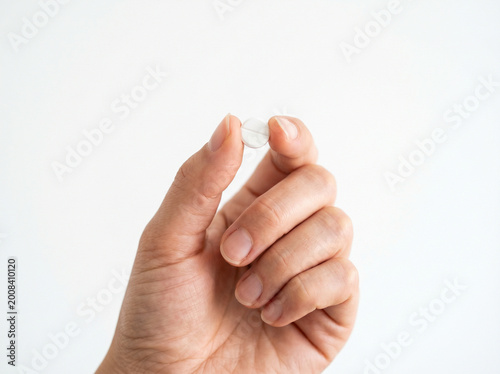 hand holding a pill