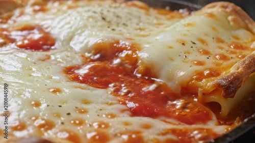 Close-up of bubbling hot lasagna with melted cheese and tomato sauce