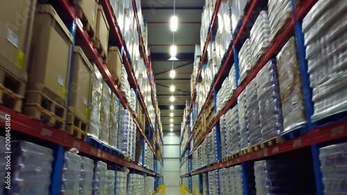 Modern industrial warehouse interior with high-density shelving and organized pallet storage for global logistics and supply chain management.