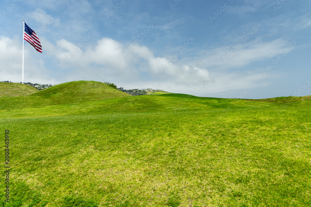 Fototapeta premium Green grass hill under blue sky minimal landscape background
