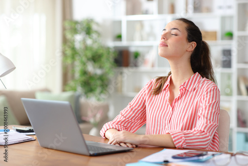 Teleworker breathing fresh air relaxing working at home