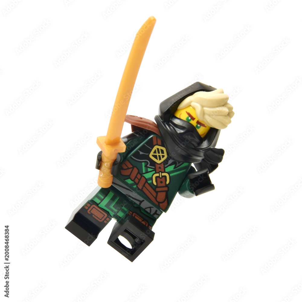 Obraz premium Editorial illustrative image of collectable lego minifigure of green ninja Lloyd with golden blade or sword weapon isolated on white.