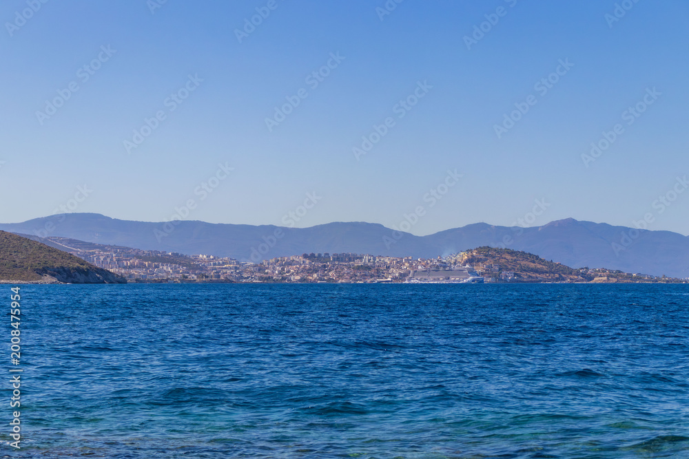 Fototapeta premium Beautiful coastal landscape with turquoise sea, rocky shore and green hills. Travel, vacation, summer holiday and tourism concept.