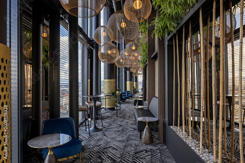 Modern high-rise lounge interior with panoramic city view, stylish seating, and decorative lighting