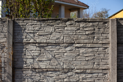 Gray stone fence around the house