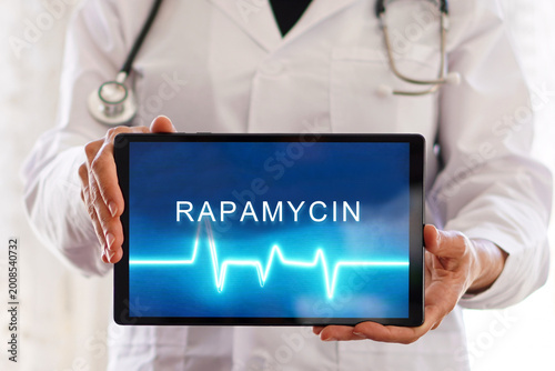 rapamycin. Healthcare professional holding a digital tablet. Longevity medicine concept.