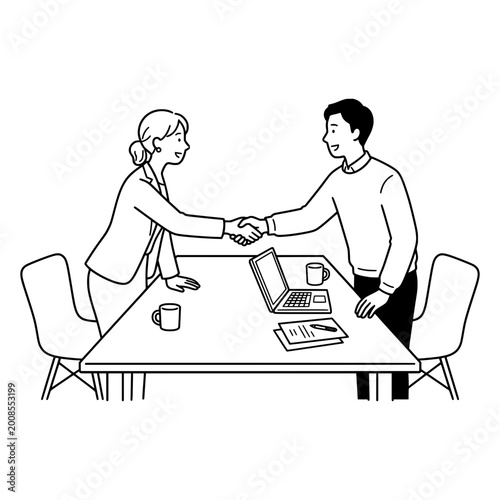 Business partners shake hands over a desk to finalize a successful collaborative agreement in a professional office environment.