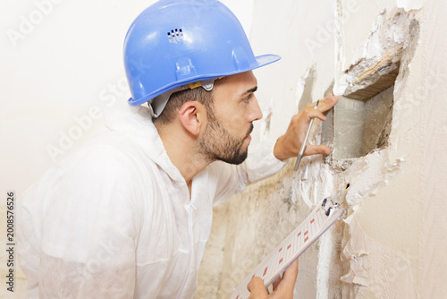 man and wall problem inspection