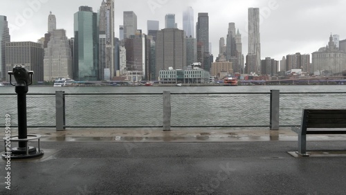 Manhattan downtown skyline from Brooklyn Bridge Park, New York City, United States. Financial district skyscrapers buildings. American architecture of business center. Tower viewer binocular telescope
