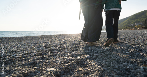 Bild auf Leinwand walking on the pebble beach