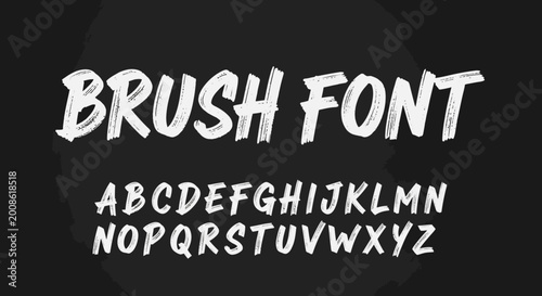 Bold white handwritten brush font alphabet on black background
