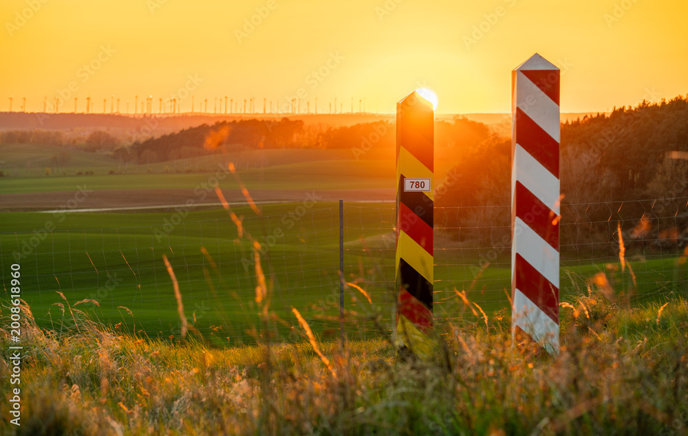 Fototapeta premium Border posts along the Polish-German border, which runs through ecologically significant green fields