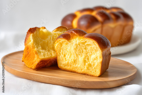 Freshly Baked Traditional French Brioche on a Wooden Plate with Soft Texture and Golden Color