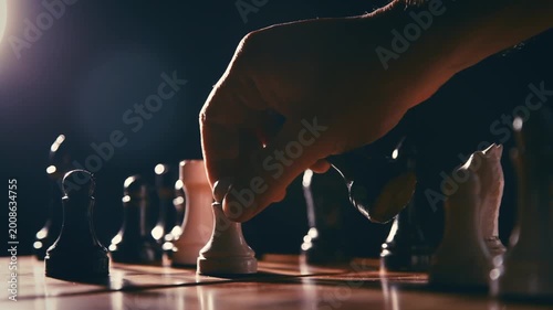 A man moves a pawn that defeats a king. Chess pieces on a board. 1920x1080