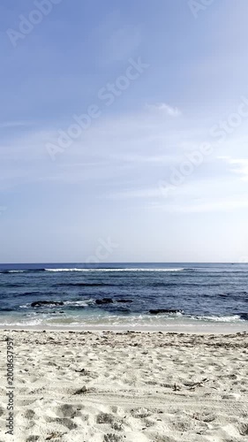 Serene tropical beach landscape with white sand and blue ocean waves