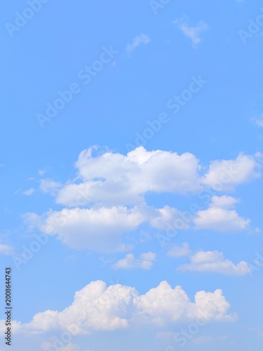 Beautiful blue sky background with white clouds on a clear sunny day for nature wallpaper and copy space design concepts