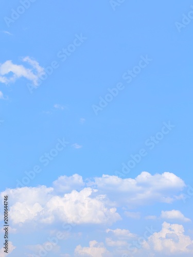 Beautiful blue sky background with white clouds on a clear sunny day for nature wallpaper and copy space design concepts