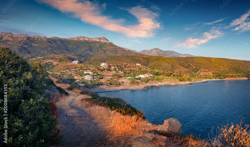 Fototapeta premium Splendid summer view of country road to the beach on Ionian sea. Wonderful evening landscape of small resort in Greece. Attractive outdoor scene of Peloponnese peninsula with beautiful mountains. 