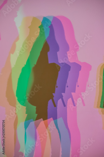 Colorful shadows cast on a wall through RGB lighting