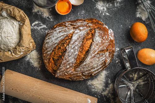 фотографія Homemade whole grain bread with baking ingredients