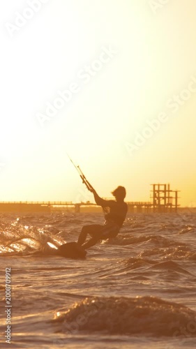 kitesurfing pro big air jump sunset silhouette slow motion technique skill extreme sports professional