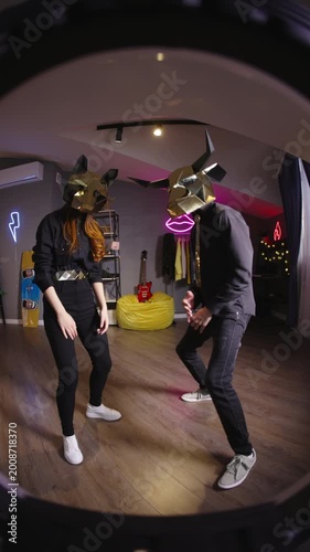 Teen creators wearing gold animal masks filming synchronized dance for short form challenges creator economy ugc fan cam culture virtual performance vibe modern home studio