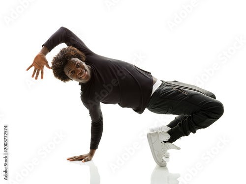Bild auf Leinwand Athletic young black breakdancer performing a one-hand stand freeze on white bac