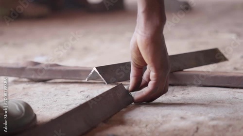 Close up of cut steel angle bars on a workshop floor